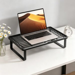 White aluminum monitor stand riser with open grid surface on a wooden desk