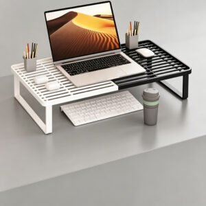 White and black monitor stand risers side by side with a laptop on top